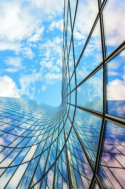 sky view next to sleek corporate glass building